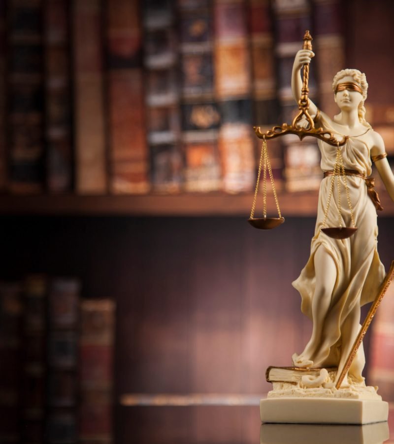 Law theme, mallet of the judge, wooden desk, books